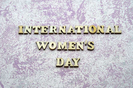 Wooden letters on a blue background. International Women's Day. A celebration of all women.の写真素材