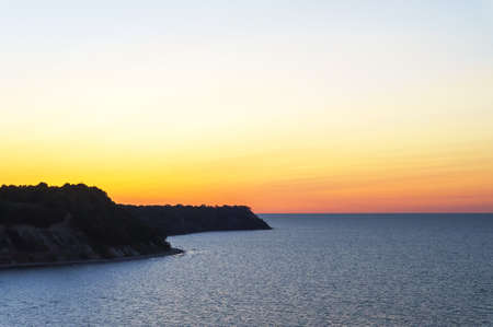 Sunset over the sea. Reflection of sunlight in the sea waves. The sky in the sunset rays. Baltic Sea.の写真素材
