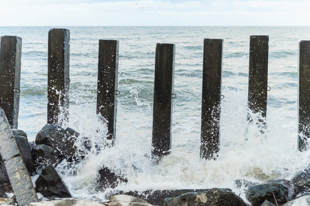 Protection of the shore from the waves. The waves hit the breakwaters. Strengthening the shore breakwaters.の写真素材