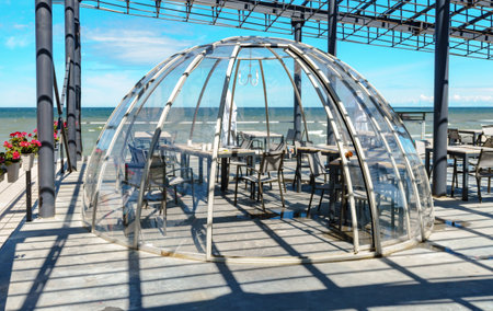 Zelenogradsk, Gnezdo cafe, Kaliningrad region, Russia, July 17, 2022. Cafe under a glass dome. The promenade of the Baltic Sea. A restaurant on the seashoreのeditorial素材