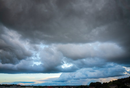 Thunderclouds over the city. The sky in black clouds. Rainy weather.の写真素材