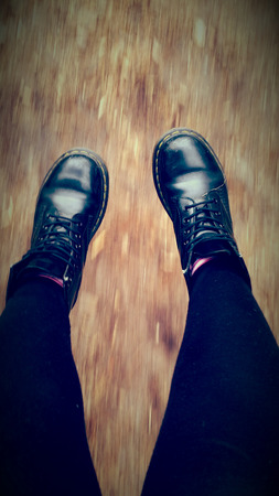 Image of a motion blurred floor whith the boots in focus.