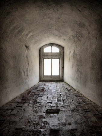 A grey textured tunnel leading into a small window. The nature of the image creates an optical illusion.の写真素材