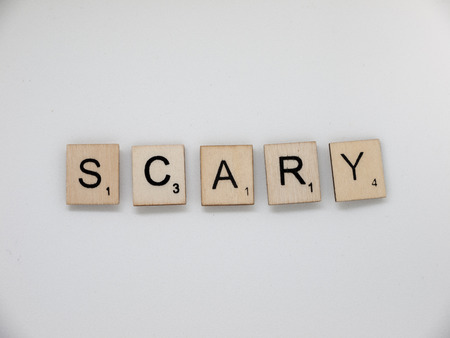 Llanelli, Wales, UK - August 28, 2017: Word 'Scary' in Scrabble tiles on white background. Scrabble is a fun and educational game distributed by Hasbro.のeditorial素材