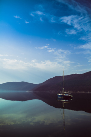 The yacht on the lake in the calmの写真素材