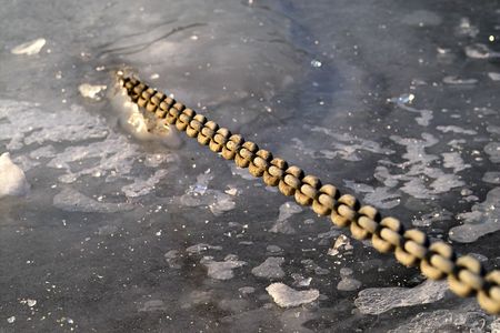 a chain breaking out of a frozen river