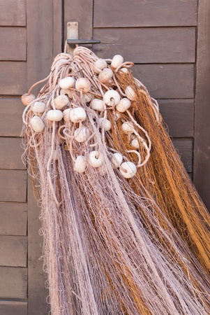 a macro of a fishing net hanging in the sun to dryの写真素材