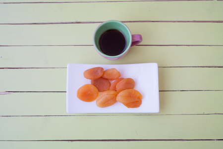 Pitted apricots on a green wooden table seen from aboveの写真素材