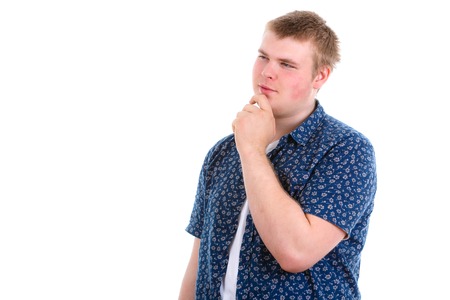 Closeup portrait of a man resting chin on hand daydreaming staring thoughtfully left copy space to left isolated on white backgroundの写真素材