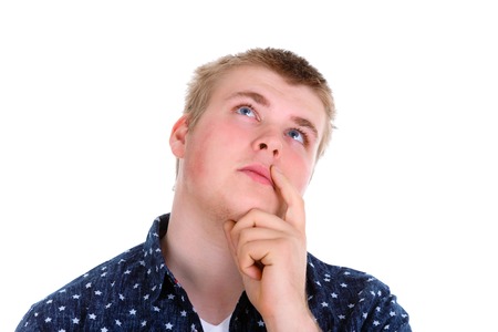 Closeup portrait of young man sad student thinking daydreaming deeply about something chin on hand...