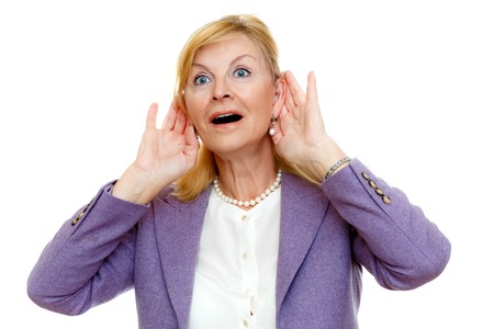 Elderly woman old senior 60-65 years woman with hardness of hearing listening, Bad hearing, white teeth, in suit with big blue eyes, isolated on white background, human emotion, facial expressionの写真素材