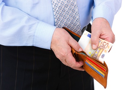Close-up portrait of businessman hands, put money of euro in leather wallet, isolated on white...