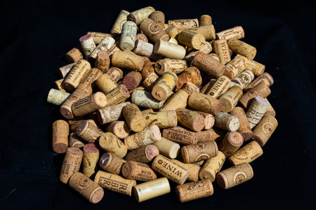 stacked wine corks on black background