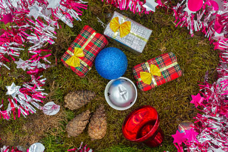 Christmas gifts. Decoration with moss, pinecones and gifts. Christmas time. Christmas gifts. Cold...
