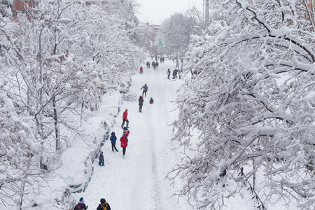 Streets and parks of Madrid covered with snow. Cold winter. Big snowfall in the city