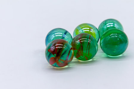 Six colored marbles on white background. Childish games