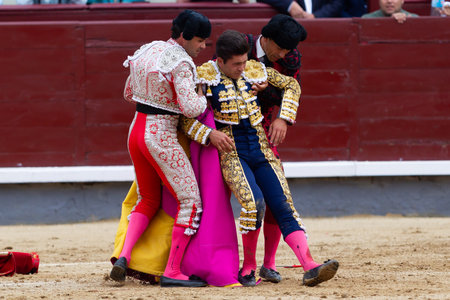 Madrid, Spain- June 2, 2022: Rafael Gonzalez suffers a catch during his alternative at the Las Ventas bullring in Madrid. bullfights Bullfighter with a crutch.のeditorial素材