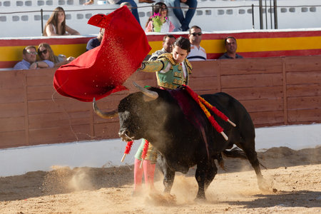 Madrid, Spain- June 19, 2022: Bullfight in the town of Villarejo de SalvanÃ©s. Bullfighter with a crutch in the bullring.のeditorial素材