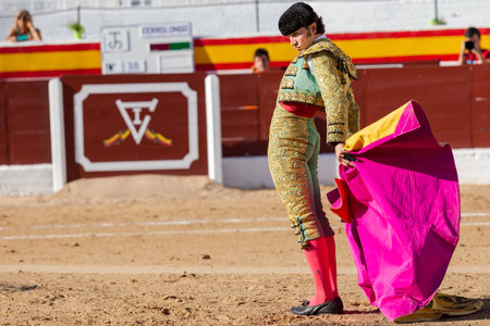 Madrid, Spain- June 19, 2022: Bullfight in the town of Villarejo de SalvanÃ©s. Bullfighter with capote in the bullring.のeditorial素材