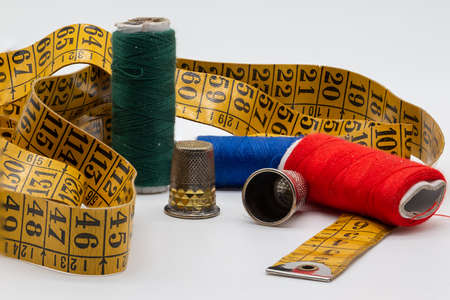 sewing objects. Thimbles, colored threads, stick tape on wooden background. haute coutureの写真素材