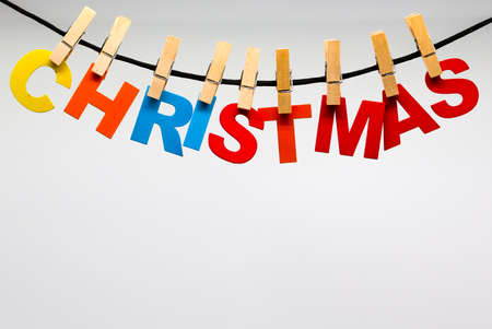Colored letters attached with wooden clothespins form the word Christmas. christmas holidaysの写真素材