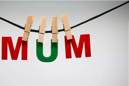 The word MUM made of wooden clothespins on a rope with clothespinsの写真素材