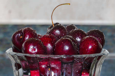 Red cherries in a glass jar. summer fruits. fresh-fruit Berries. Healthy food.