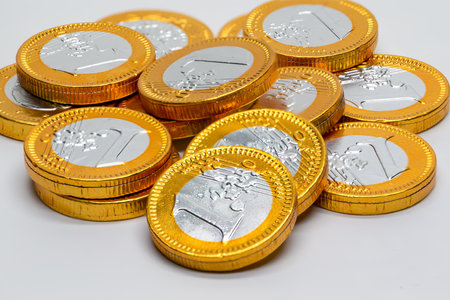 1 euro coins filled with chocolate. Macro photo of coin shaped chocolate bars. Sweet foods. Milk chocolate. halloween partiesの写真素材