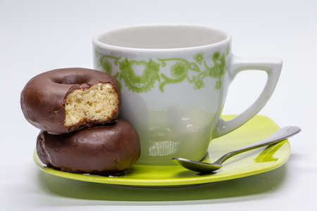Chocolate donuts with cup of coffee. Snack with sugar. Sweet buns. Craft confectionery.の写真素材