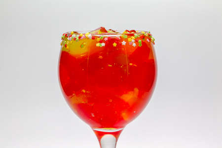 Fruit jelly cocktail. Glass cup filled with strawberry jelly and rims of stars with sugar. Gelatin mix. Sugary drinks. Cool drinks.の写真素材
