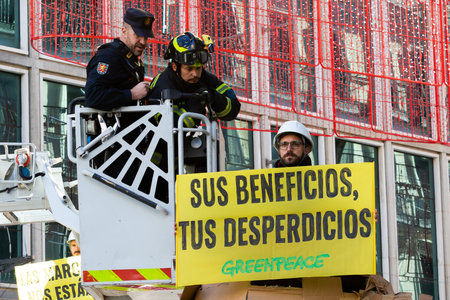 Madrid, Spain- November 25, 2022: Greenpeace demonstrates in Plaza de Callao in Madrid against Black Friday. Police evict Greenpeace activists.のeditorial素材