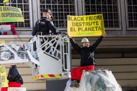 Madrid, Spain- November 25, 2022: Greenpeace demonstrates in Plaza de Callao in Madrid against Black Friday. Police evict Greenpeace activists.のeditorial素材