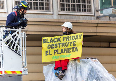 Madrid, Spain- November 25, 2022: Greenpeace demonstrates in Plaza de Callao in Madrid against Black Friday. Police evict Greenpeace activists.のeditorial素材