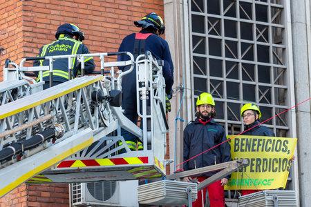 Madrid, Spain- November 25, 2022: Greenpeace demonstrates in Plaza de Callao in Madrid against Black Friday. Police evict Greenpeace activists.のeditorial素材