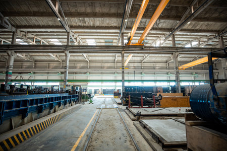 The interior of a big industrial building or factory with steel and concrete constructionsの写真素材