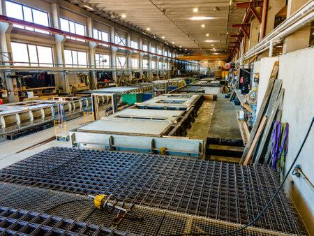 The interior of a big industrial building or factory with steel and concrete constructionsの写真素材