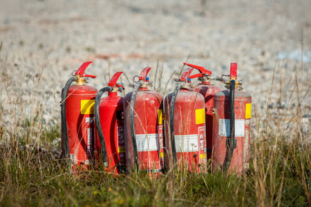 Red tank of fire extinguisher. Overview of a powerful industrial fire extinguishing system. Emergency equipment for industrial refinery crude oil and gasの写真素材