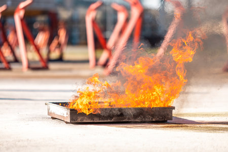Fire flame in steel bucket for demonstrate to extinguish fireの写真素材