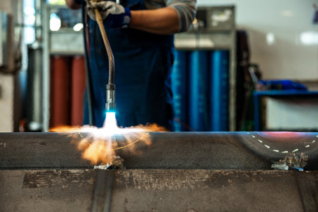 Heating up of metal construction with acetylene and oxygen burner in process of flame straightening with visible red colour of heated metalの写真素材