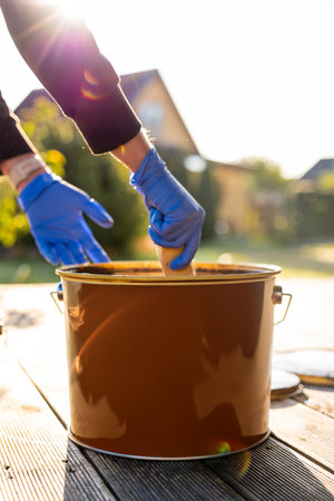 Close-up of an open can of patio oil to protect wooden boardsの写真素材