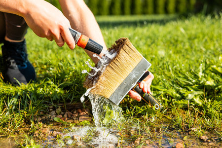 Washing a brush cleaning after the painting work finished jobの写真素材