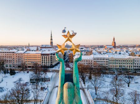 Beautiful sunrise view over Riga by the statue of liberty - Milda in Latvia. The monument of freedom.の写真素材