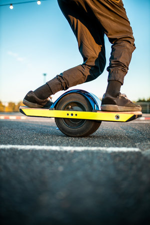 close-up of a rider's foot on an electric skateboard with glowing lights navigating through cones