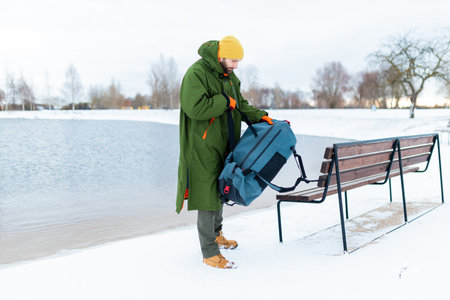 Young man is preparing for a cold winter swim, a healthy lifestyle.の写真素材