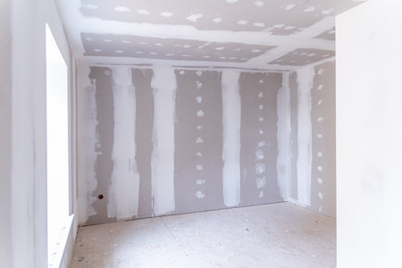 Interior of a house under renovation with drywall installation and joint compound applicationの写真素材