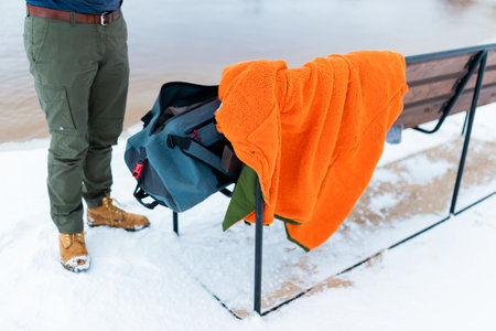 Winter swimming change robe. A man changes clothes after swimming in the cold winter lake.の写真素材