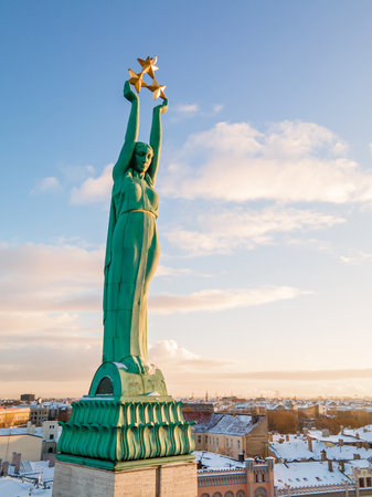 Beautiful sunrise view over Riga by the statue of liberty - Milda in Latvia. The monument of freedom.の写真素材