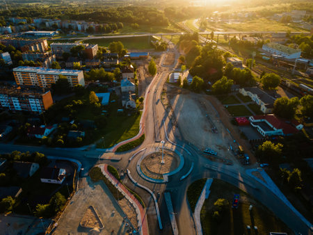 Sunlit Aerial View of Urban Landscape with Under-Construction Roundabout & Shadowsの写真素材