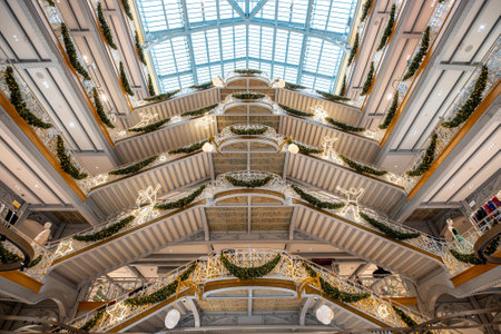 elegant interior of a multi-story shopping gallery adorned with festive christmas decorations and glowing lights, a luxurious shopping experienceの写真素材