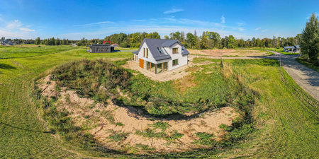 Modern new-build house with a metal roof and large windows in a rural settingの写真素材